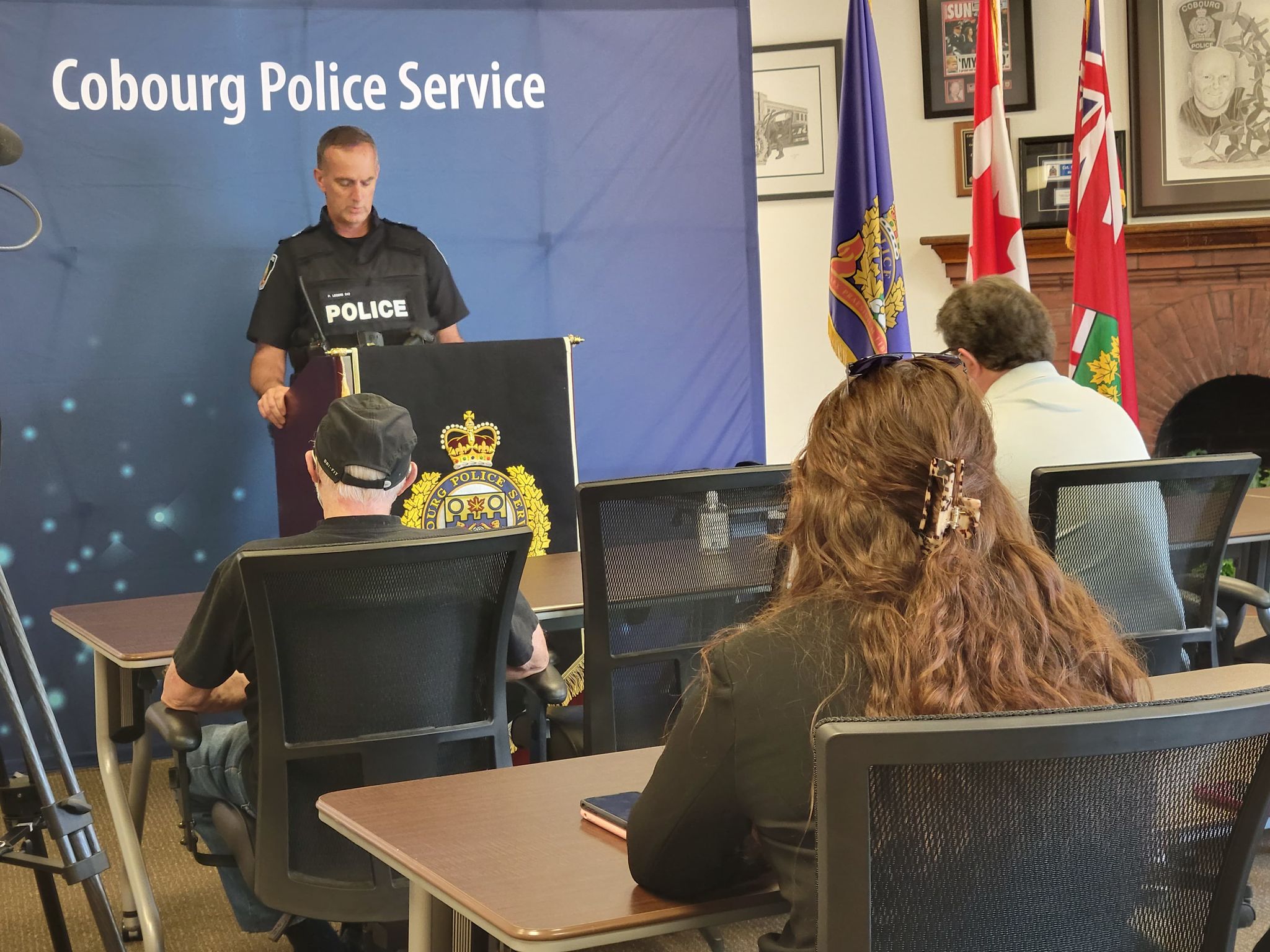 Police officer giving presentation at a podium